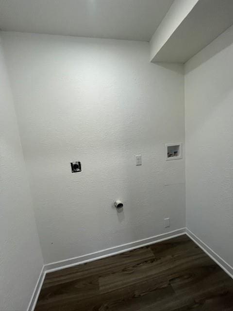 washroom with dark wood-style flooring, hookup for a washing machine, baseboards, electric dryer hookup, and laundry area