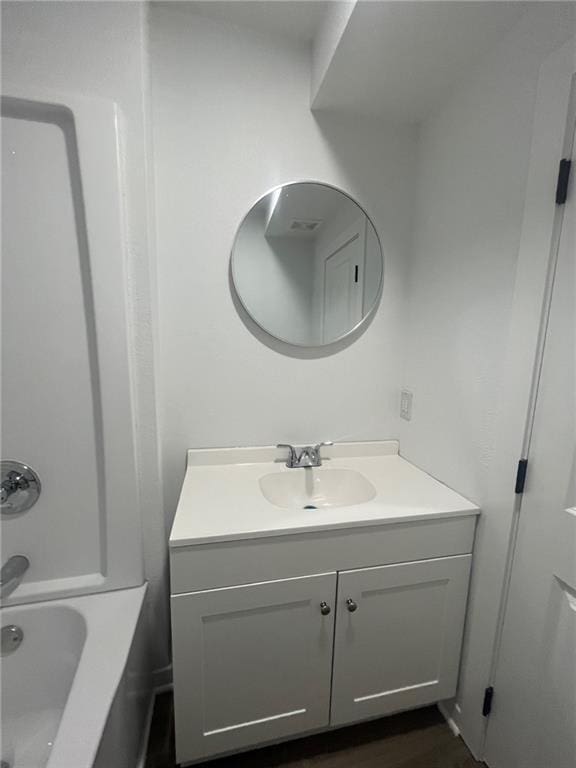 bathroom with vanity and wood finished floors