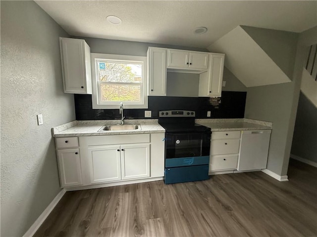 kitchen featuring white cabinetry, a sink, white dishwasher, and range with electric stovetop
