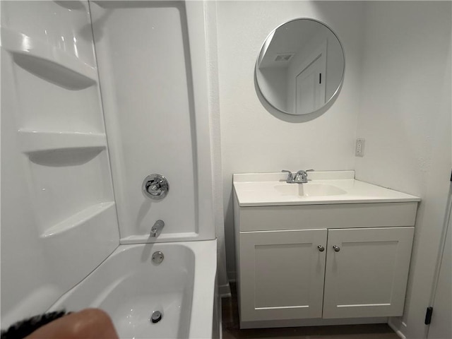 full bath featuring vanity, washtub / shower combination, and visible vents