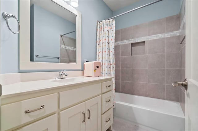 bathroom with shower / tub combo and vanity
