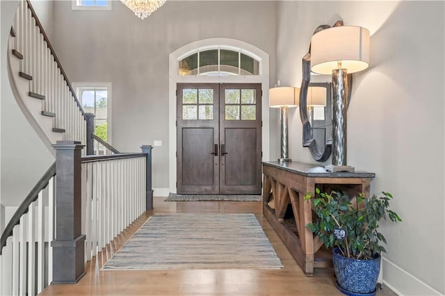 16401 W Loch Lloyd Pkwy, Loch Lloyd, MO 64012 - entryway with healthy amount of natural light, a high ceiling, stairs, and wood finished floors