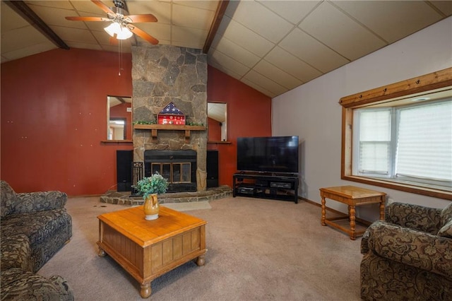 living area featuring vaulted ceiling with beams, carpet flooring, ceiling fan, and a fireplace