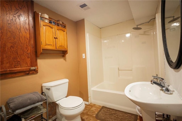 full bath featuring visible vents, a sink, baseboards, toilet, and tub / shower combination