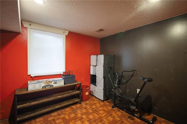 misc room featuring visible vents and a textured ceiling