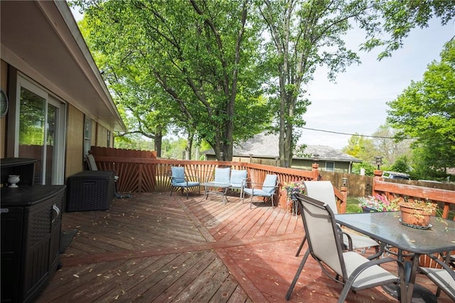 wooden deck featuring fence and outdoor dining space