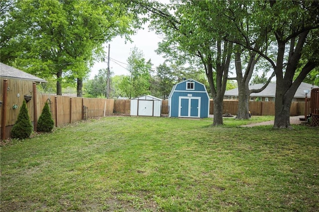 view of yard with a storage unit, a fenced backyard, and an outdoor structure