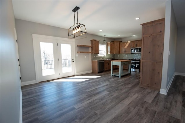 kitchen with backsplash, open shelves, appliances with stainless steel finishes, and baseboards