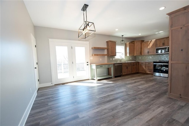 kitchen featuring open shelves, appliances with stainless steel finishes, baseboards, tasteful backsplash, and pendant lighting