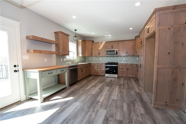 kitchen featuring open shelves, wood finished floors, recessed lighting, backsplash, and stainless steel appliances