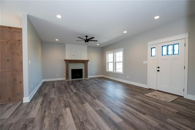 unfurnished living room featuring recessed lighting, ceiling fan, baseboards, and dark wood-type flooring