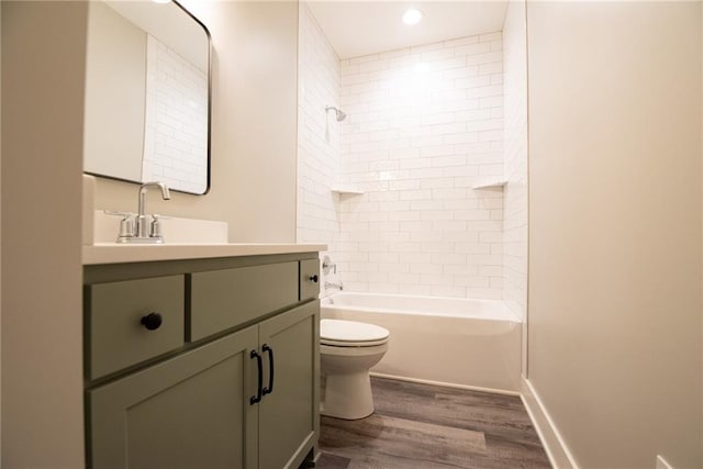bathroom featuring bathtub / shower combination, vanity, toilet, recessed lighting, and wood finished floors