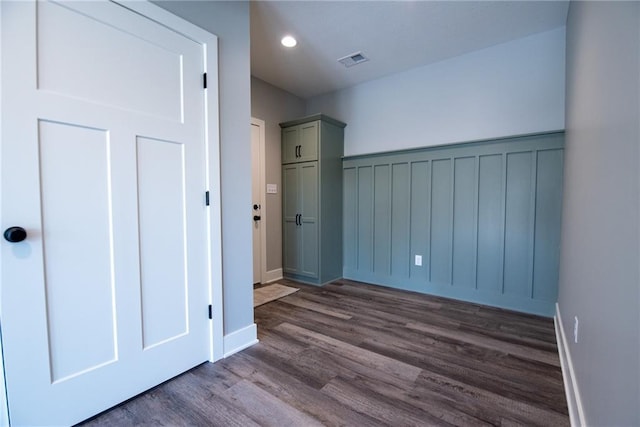 unfurnished bedroom featuring recessed lighting, baseboards, dark wood-style flooring, and visible vents