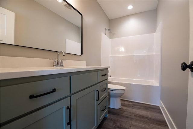 full bathroom featuring vanity, toilet, shower / bath combination, wood finished floors, and visible vents