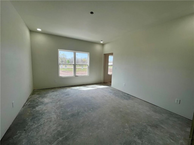 unfurnished room with unfinished concrete floors
