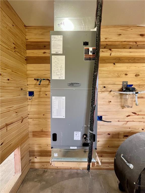 utility room featuring heating unit