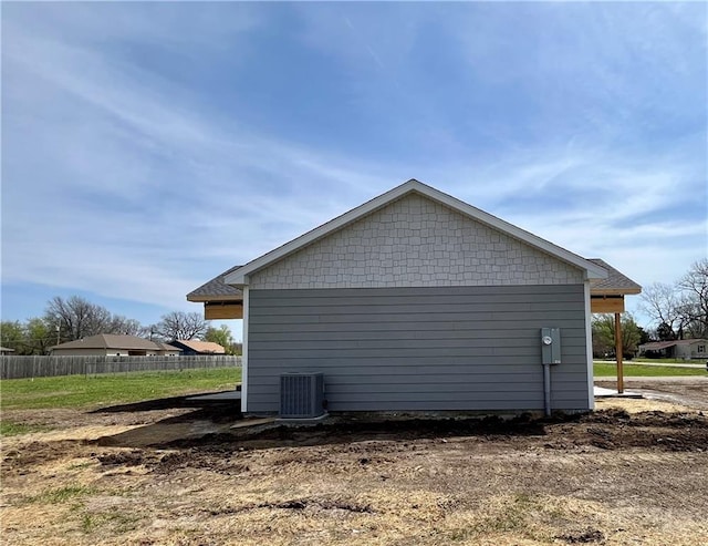 view of property exterior featuring cooling unit and fence