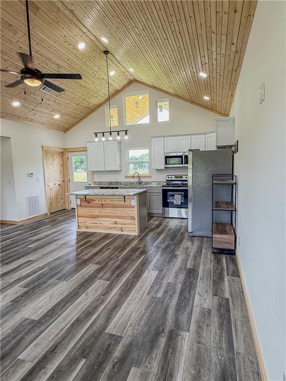 906 Park St, Cherryvale, KS 67335 - kitchen with appliances with stainless steel finishes, high vaulted ceiling, light countertops, white cabinetry, and wooden ceiling