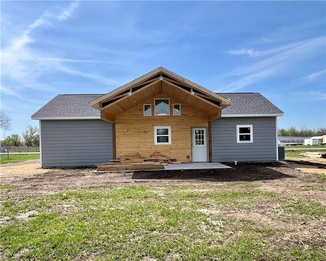 906 Park St, Cherryvale, KS 67335 - back of house featuring a patio area, roof with shingles, and a yard