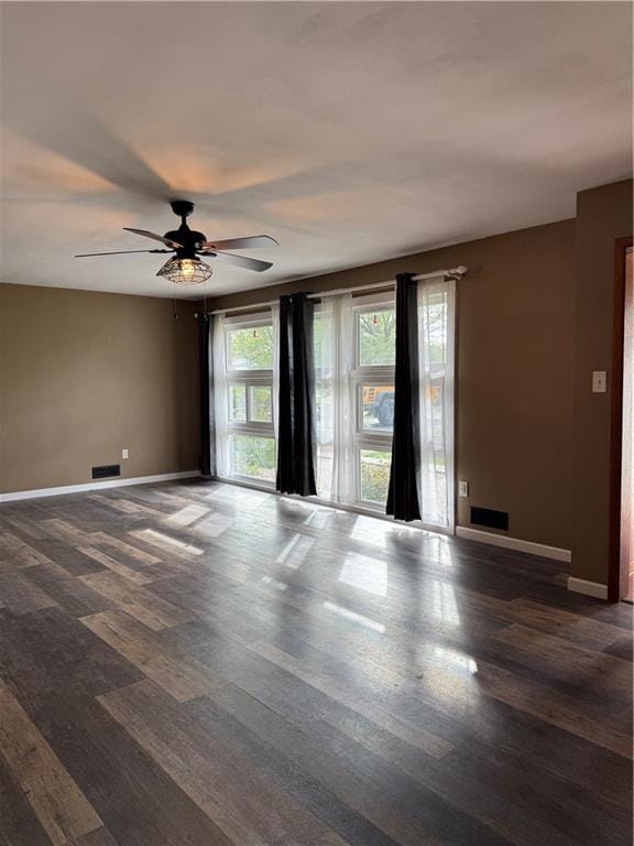 1020 Francis St, Lexington, MO 64067 - unfurnished room with baseboards, a ceiling fan, dark wood-type flooring, and visible vents