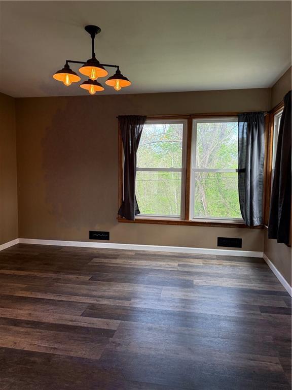 1020 Francis St, Lexington, MO 64067 - unfurnished room with visible vents, baseboards, and dark wood-style flooring