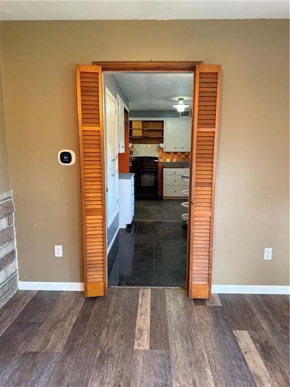 1020 Francis St, Lexington, MO 64067 - corridor with baseboards and dark wood-type flooring