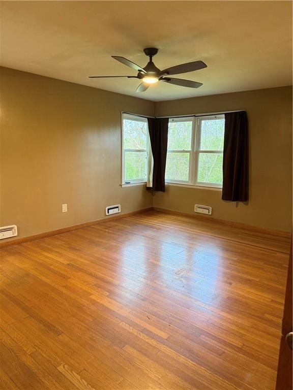 1020 Francis St, Lexington, MO 64067 - unfurnished room featuring ceiling fan, baseboards, and wood finished floors
