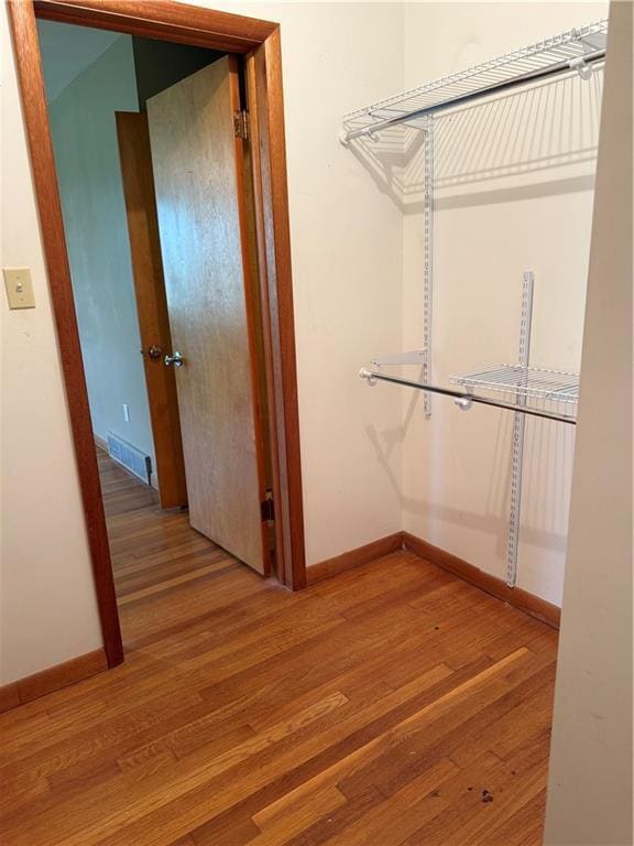 1020 Francis St, Lexington, MO 64067 - spacious closet with light wood-type flooring and visible vents