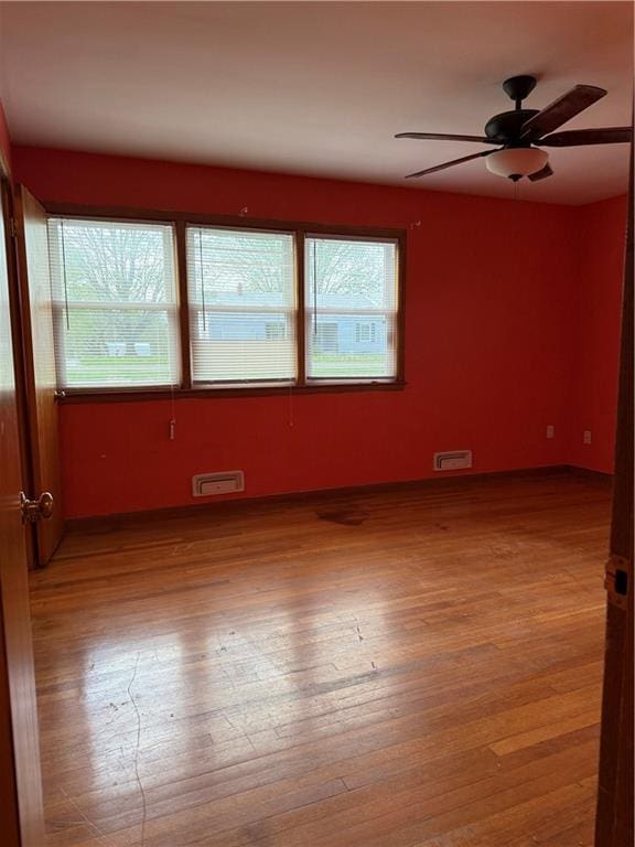 1020 Francis St, Lexington, MO 64067 - unfurnished room with wood finished floors, ceiling fan, and visible vents