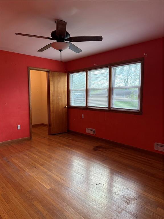 1020 Francis St, Lexington, MO 64067 - unfurnished room featuring light wood-style flooring, visible vents, a ceiling fan, and baseboards
