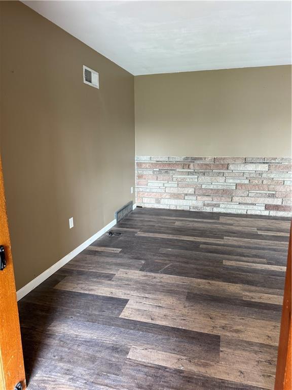 1020 Francis St, Lexington, MO 64067 - unfurnished room with baseboards, wood finished floors, and visible vents