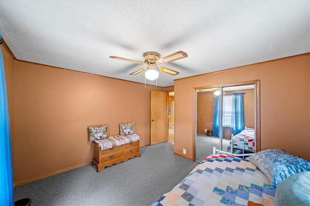 bedroom with a closet, carpet floors, a ceiling fan, a textured ceiling, and baseboards