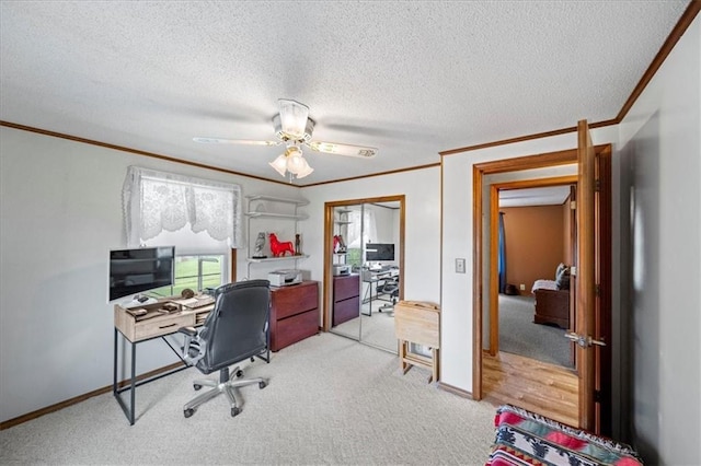 office area featuring a textured ceiling, ornamental molding, and light colored carpet