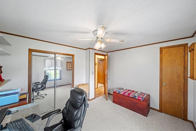office featuring a textured ceiling, baseboards, ceiling fan, ornamental molding, and light colored carpet
