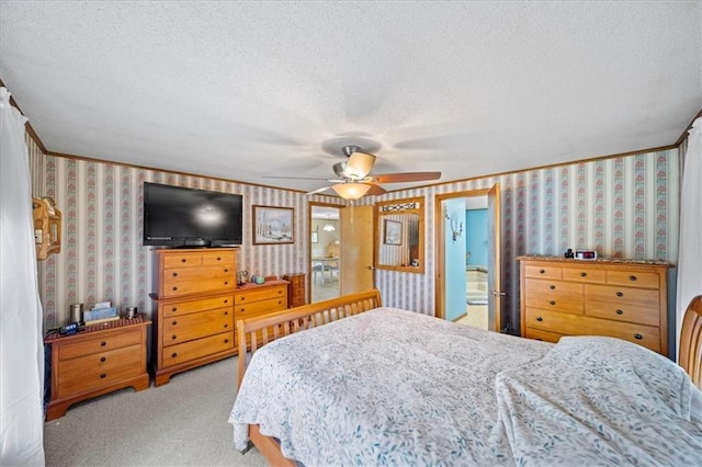bedroom with carpet flooring, a textured ceiling, and wallpapered walls