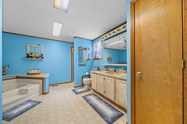 bathroom featuring a bath, baseboards, a sink, and double vanity