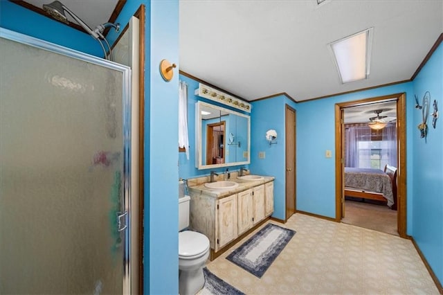 ensuite bathroom with a stall shower, toilet, a sink, ornamental molding, and double vanity