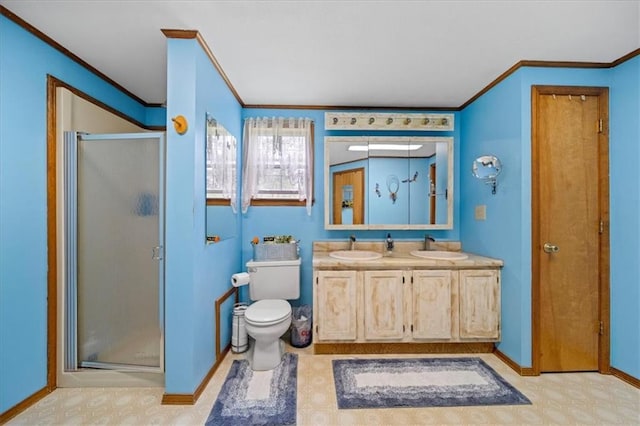 full bath featuring a sink, double vanity, ornamental molding, and a shower stall