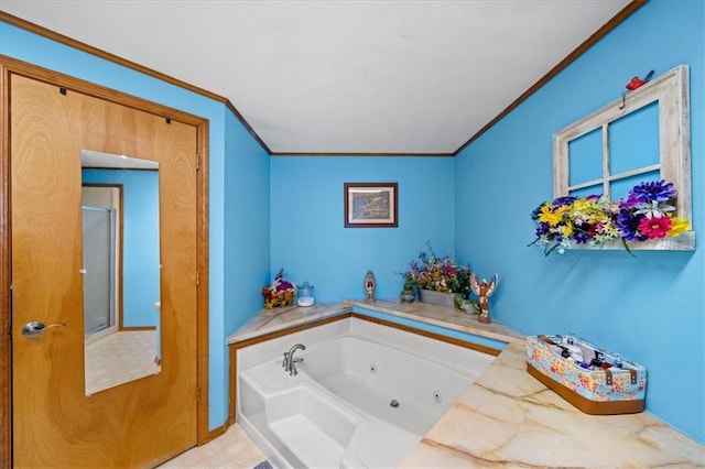 bathroom with a jetted tub and crown molding