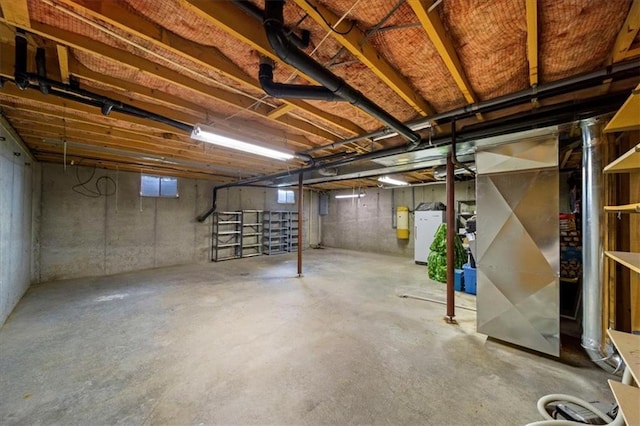 unfinished below grade area with refrigerator