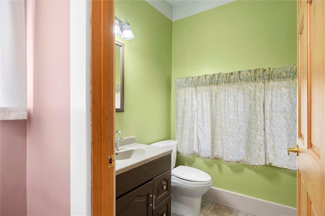 bathroom featuring tile patterned floors, toilet, and vanity