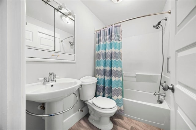 full bath with shower / bath combination with curtain, a sink, toilet, and wood finished floors