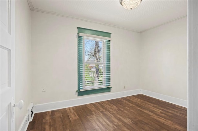 unfurnished room featuring wood finished floors, baseboards, and ornamental molding