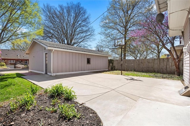 view of patio featuring an outbuilding and fence