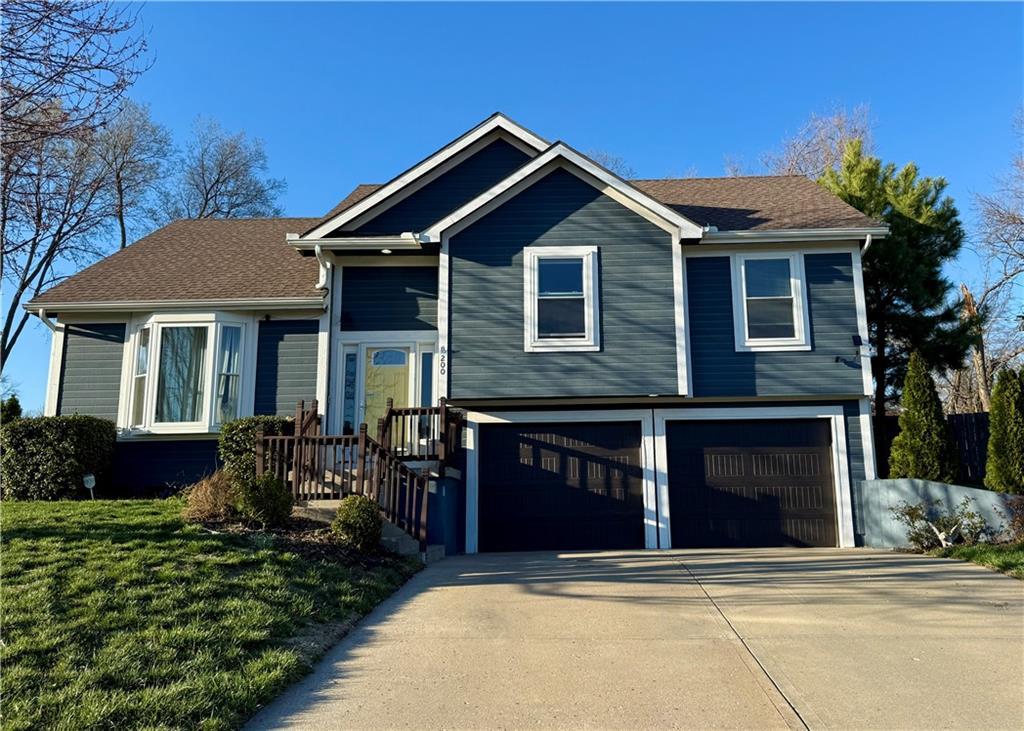 200 Echo Rdg, Buckner, MO 64016 - split level home featuring an attached garage and concrete driveway