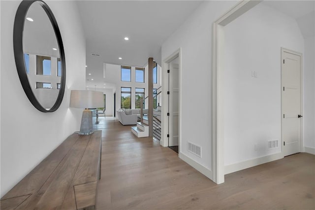 hall featuring recessed lighting, visible vents, wood finished floors, and baseboards