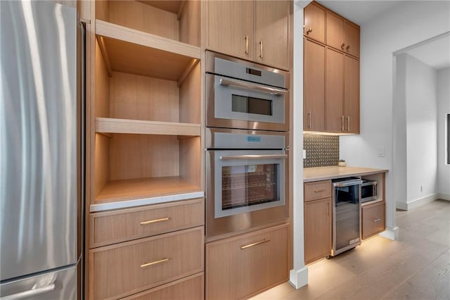kitchen with wine cooler, open shelves, appliances with stainless steel finishes, and light countertops
