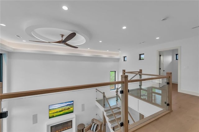 corridor featuring visible vents, recessed lighting, and an upstairs landing