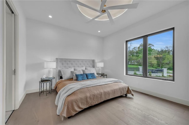 bedroom with recessed lighting, a ceiling fan, wood finished floors, and baseboards