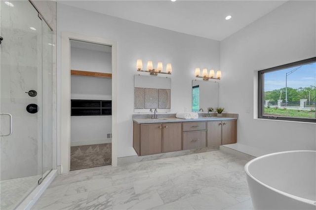 full bathroom with a marble finish shower, a sink, a freestanding bath, and double vanity